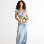 Woman in wedding attire holding a bouquet of flowers