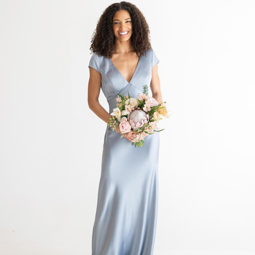 Woman in wedding attire holding a bouquet of flowers