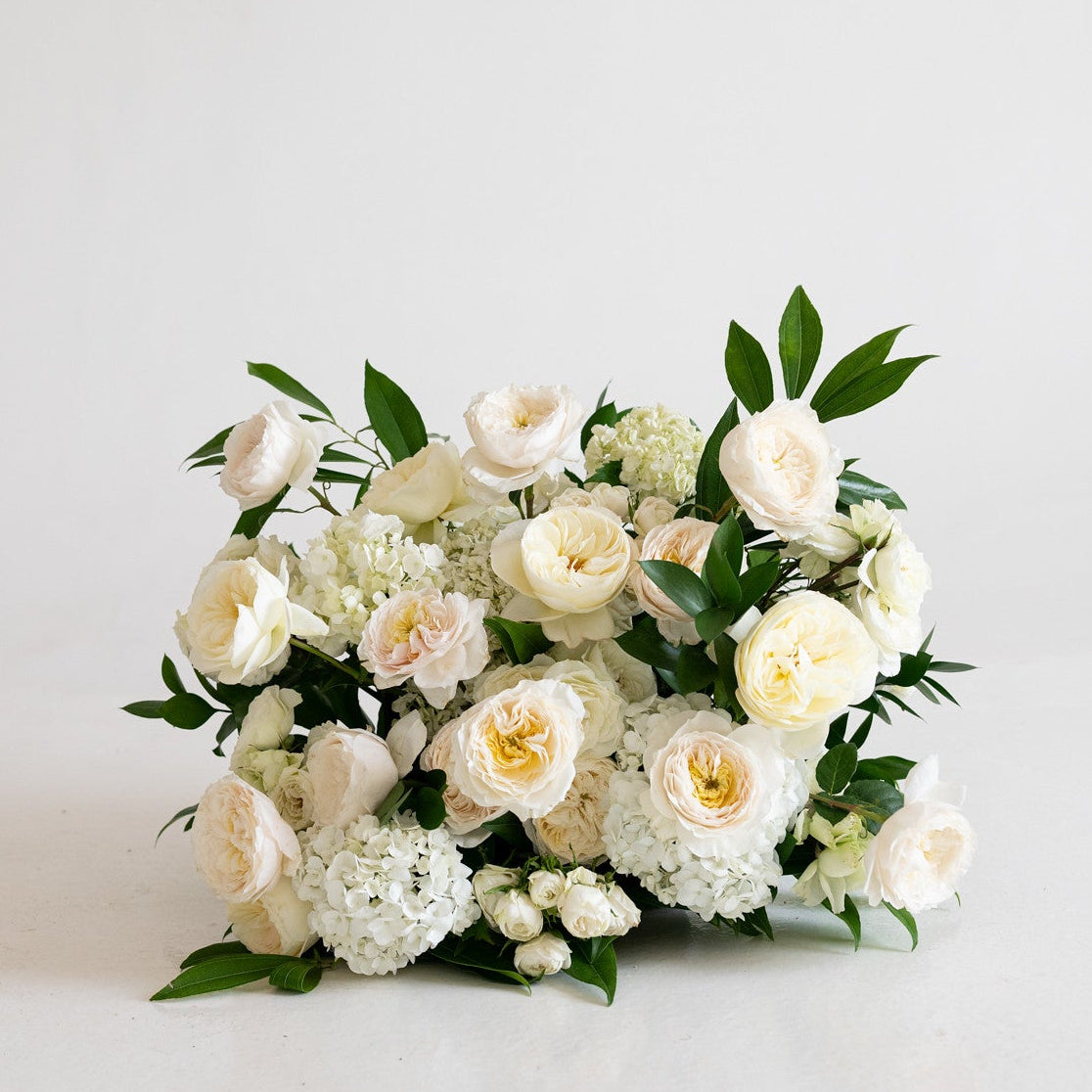 Ivory Garden Rose Grounded Ceremony Arrangement