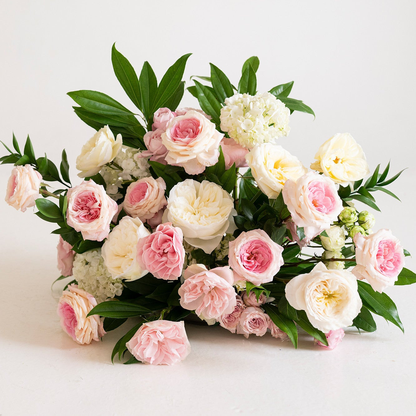 Soft Pink and Cream Garden Rose Grounded Ceremony Arrangement