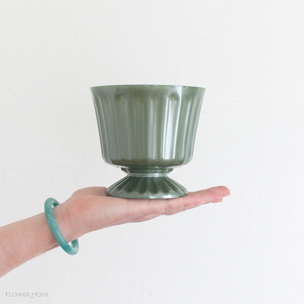 footed green plastic vase