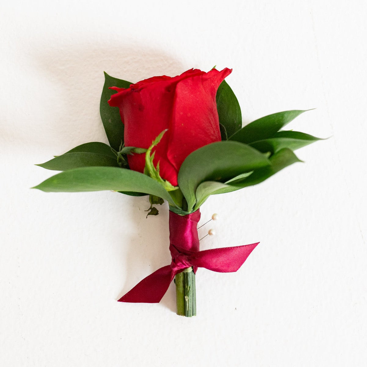 red boutonniere for prom and formals