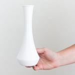 white plastic bud vase