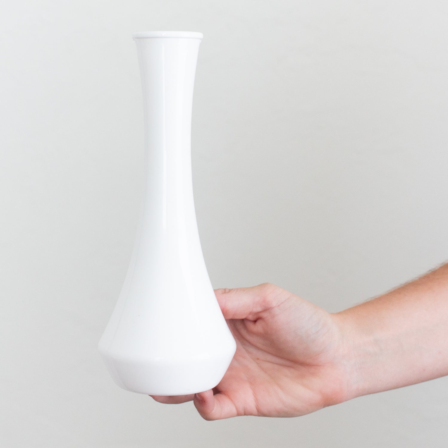 white plastic bud vase